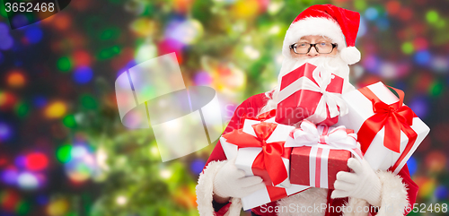 Image of man in costume of santa claus with gift boxes