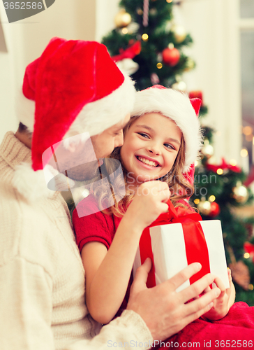 Image of smiling father and daughter opening gift box