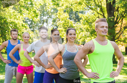 Image of group of happy friends or sportsmen outdoors