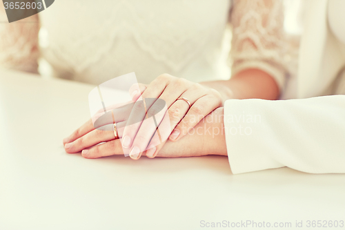 Image of close up of happy married lesbian couple hugging