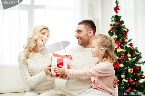 Image of happy family at home with christmas gift box