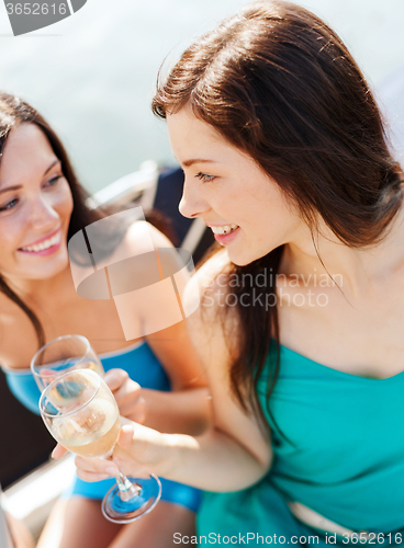 Image of girls with champagne glasses on boat