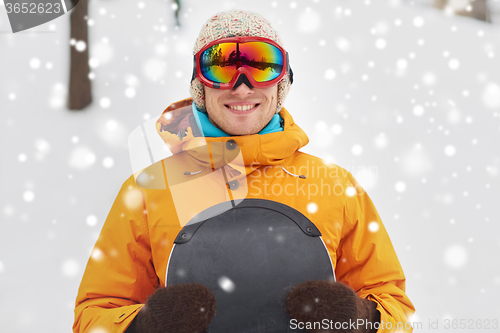 Image of happy young man in ski goggles outdoors