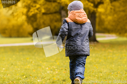 Image of little boy running outdoors