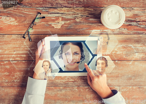 Image of close up of hands with tablet pc and helpline