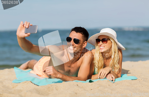 Image of happy couple in swimwear walking on summer beach