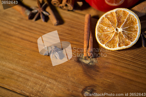 Image of cinnamon, anise and dried orange on wooden board