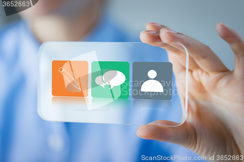 Image of close up of woman with transparent smartphone