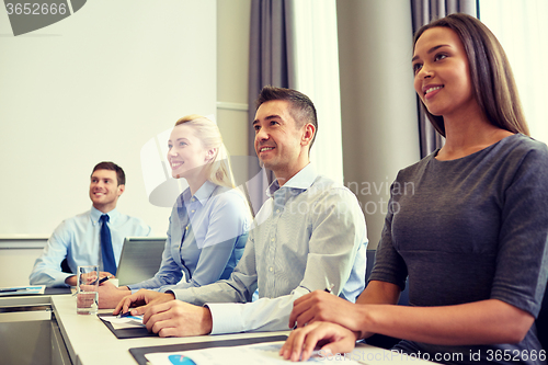 Image of smiling business people meeting in office