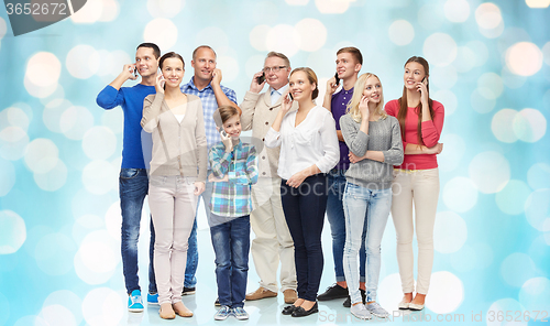 Image of group of smiling people with smartphones