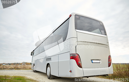 Image of tour bus driving outdoors