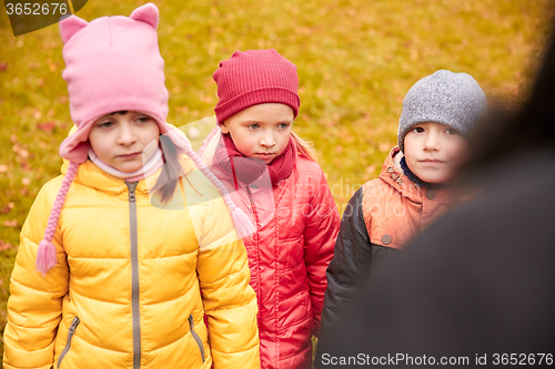 Image of sad kids being blamed for misbehavior outdoors