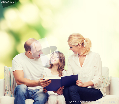 Image of happy family with book at home