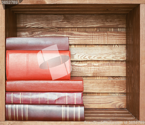 Image of books on wooden shelf