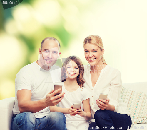 Image of happy family with smartphones