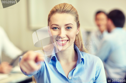 Image of smiling businesswoman pointing finger on you