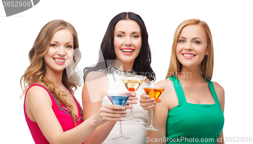 Image of three smiling women with cocktails