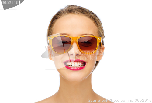 Image of happy young woman in sunglasses with pink lipstick