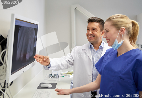 Image of dentists with x-ray on monitor at dental clinic