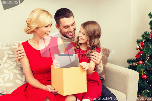 Image of smiling family with tablet pc