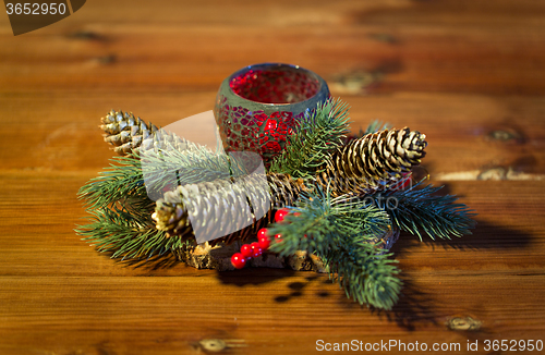 Image of christmas fir branch decoration and candle lantern