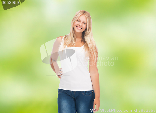 Image of smiling young woman in blank white shirt and jeans