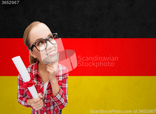 Image of smiling student with diploma over german flag