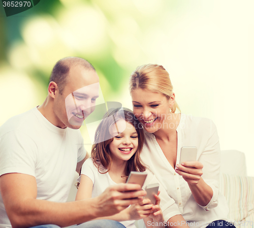 Image of happy family with smartphones