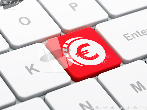 Image of Currency concept: Euro Coin on computer keyboard background