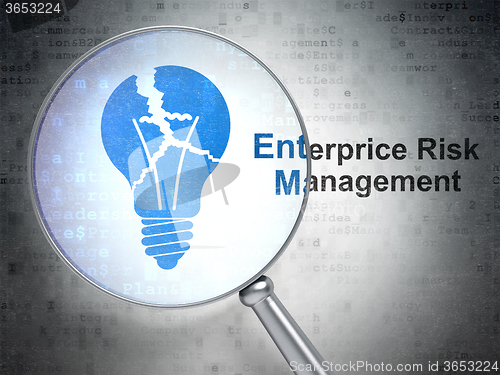 Image of Finance concept: Light Bulb and Enterprice Risk Management with optical glass