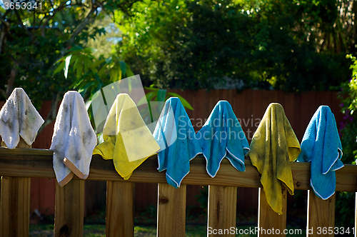 Image of dirty rags hanging on fence