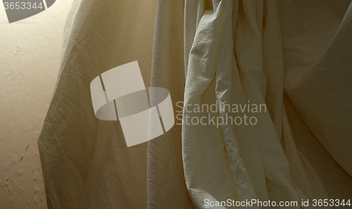 Image of draped muslin background cloth with wall