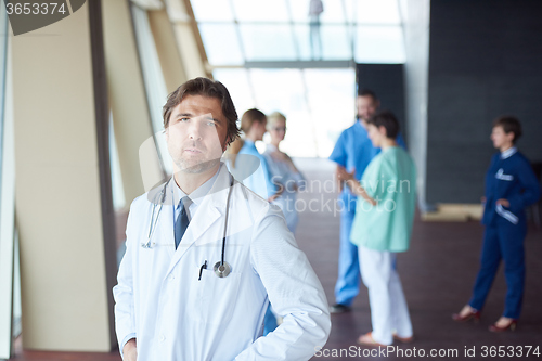 Image of group of medical staff at hospital, handsome doctor in front of 