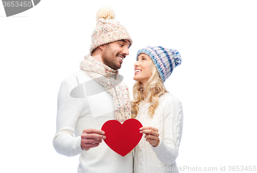 Image of smiling couple in winter clothes with red heart