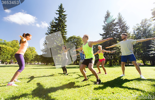 Image of group of happy friends exercising outdoors