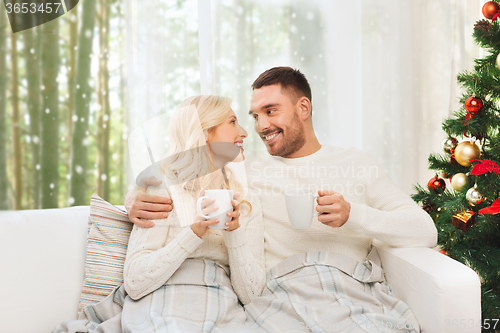 Image of happy couple at home with christmas tree