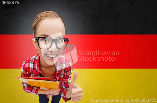 Image of happy student girl with folders showing thumbs up