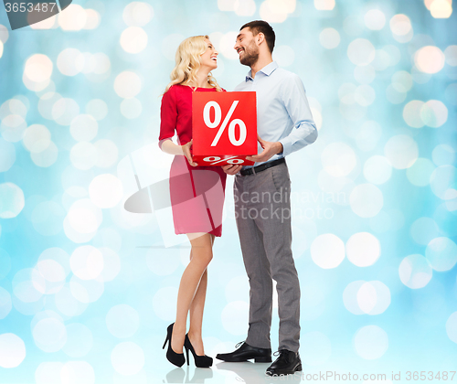Image of happy couple with red sale percentage over lights