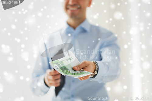 Image of close up of businessman hands holding money