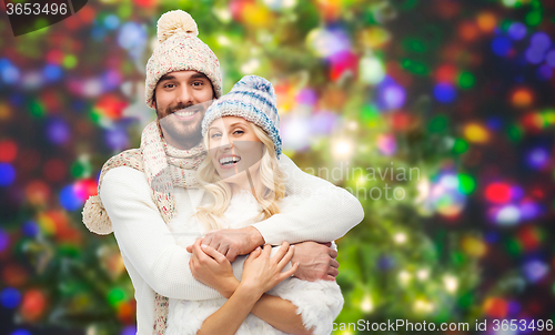 Image of smiling couple in winter clothes hugging