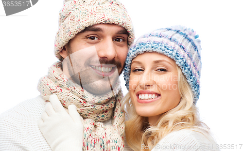 Image of smiling couple in winter clothes hugging