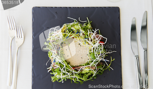 Image of close up of poultry salad with sauce at restaurant