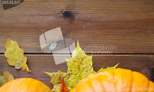 Image of close up of pumpkins on wooden table at home