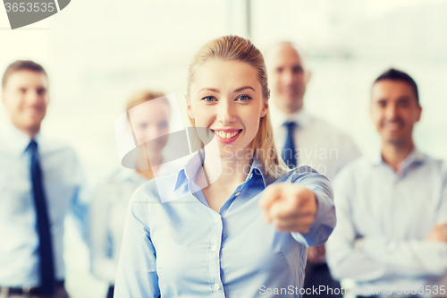 Image of smiling businesswoman pointing finger on you