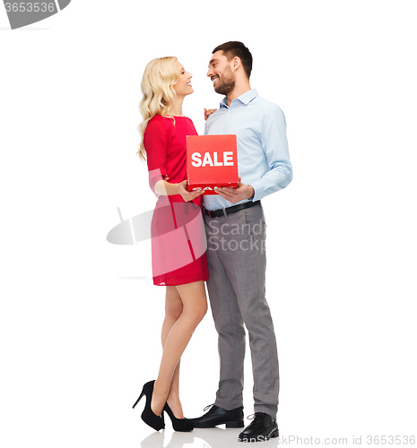 Image of happy couple with red sale sign