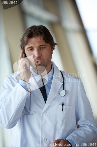 Image of doctor speaking on cellphone