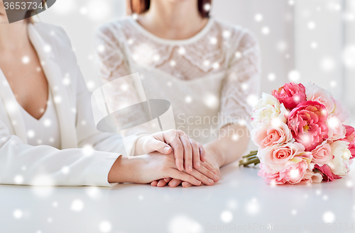 Image of close up of happy lesbian couple with flowers