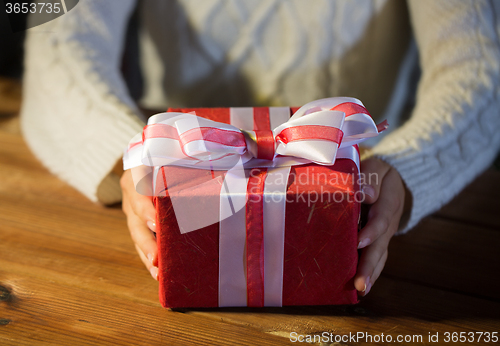 Image of close up of woman with christmas gift