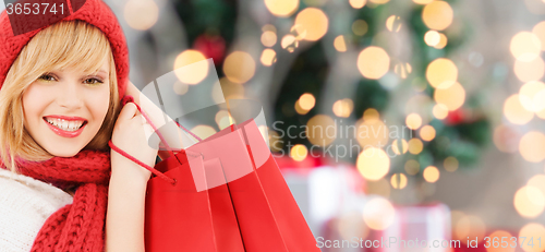 Image of smiling young woman with shopping bags