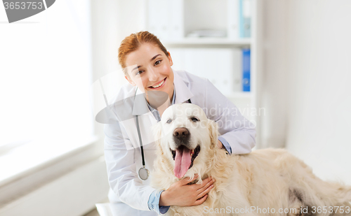 Image of happy doctor with retriever dog at vet clinic